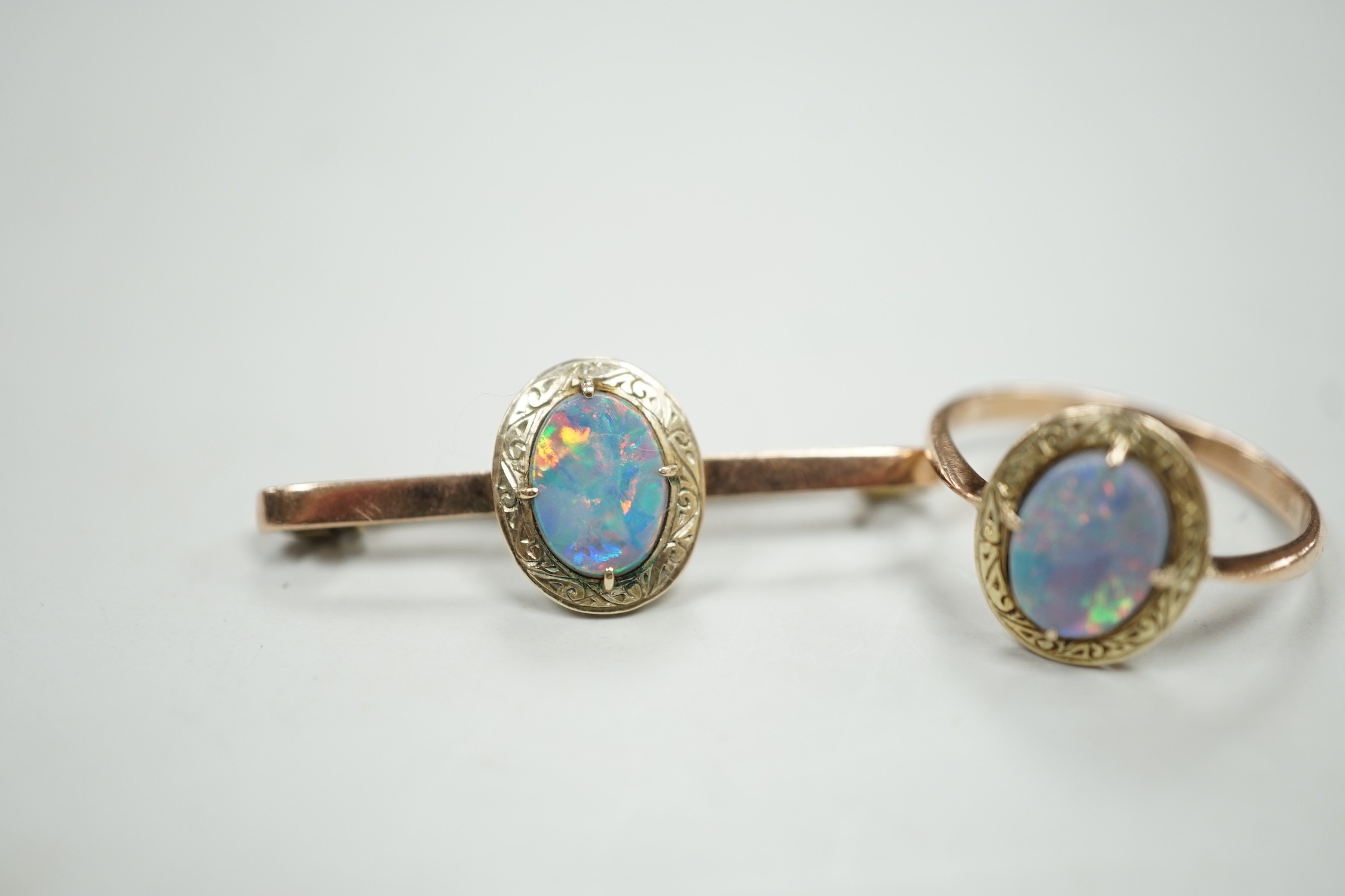 A 9ct and black opal doublet set bar brooch, 38mm and a matching ring, size R, gross weight 5.9 grams.